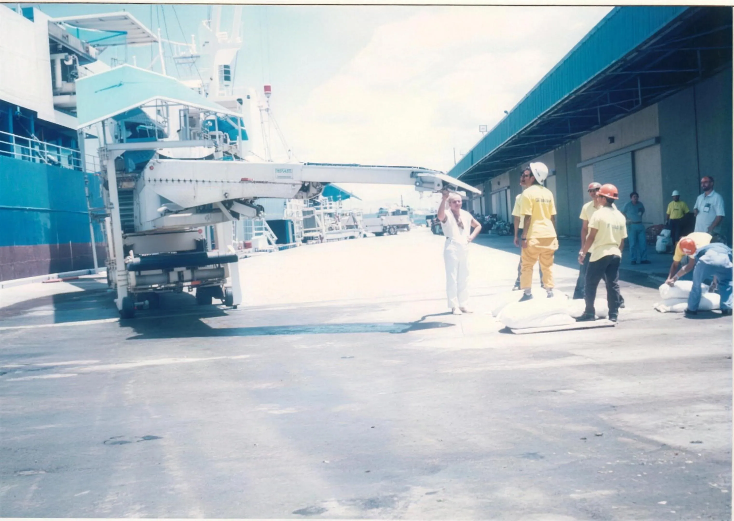 M/V Pioneer: Unloading bagged sugar using an electronic conveyor.