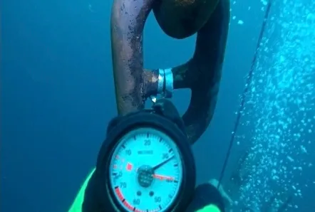 Dive photo, June 30, 2024: depth gauge reading held against a chain link